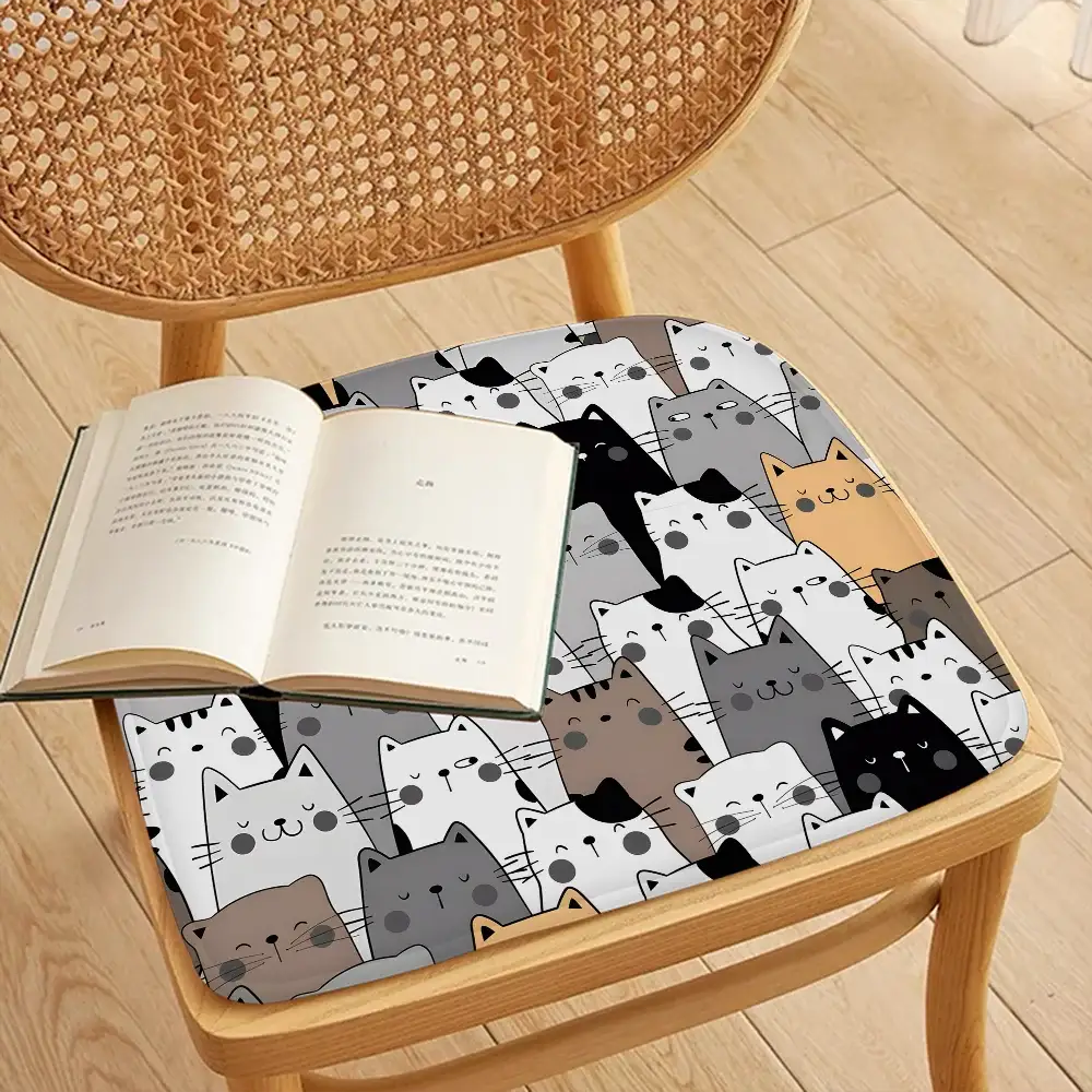 Chair cushion 45x45 cm with cute cartoon cat faces in gray, white, black and brown; Simples Market.