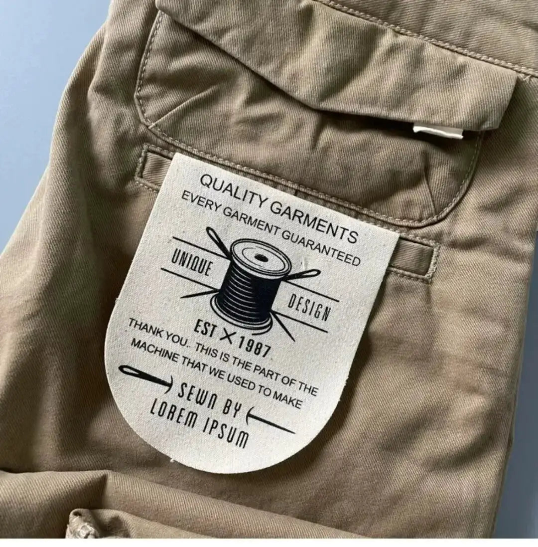 Beige men's cotton cargo pants with back flap pocket and stitched details; tag visible.