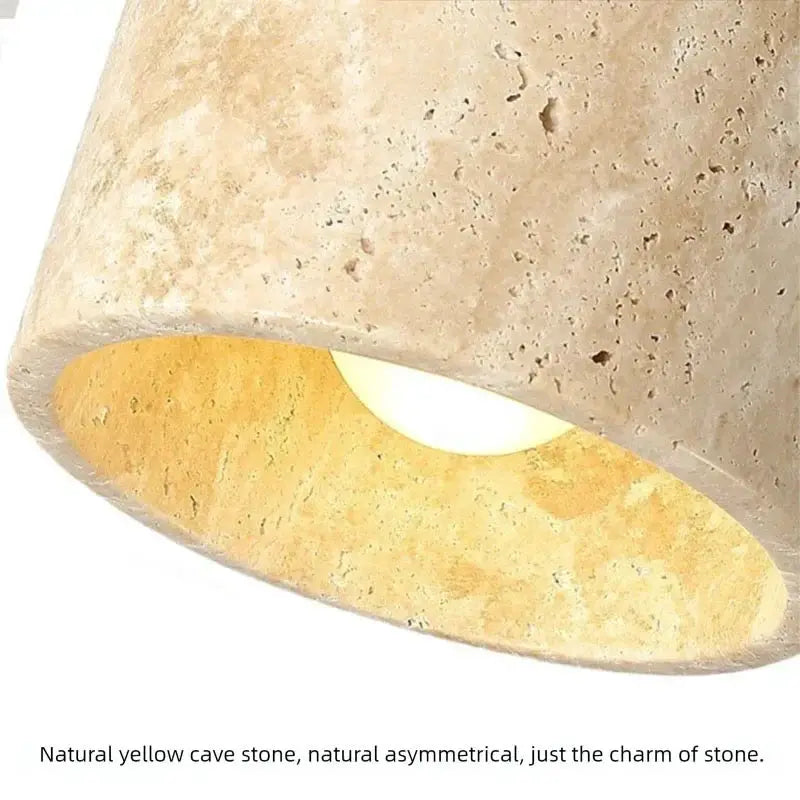 Yellow cave-stone bedside wall lamp with warm glow, Japanese-style wabi-sabi design