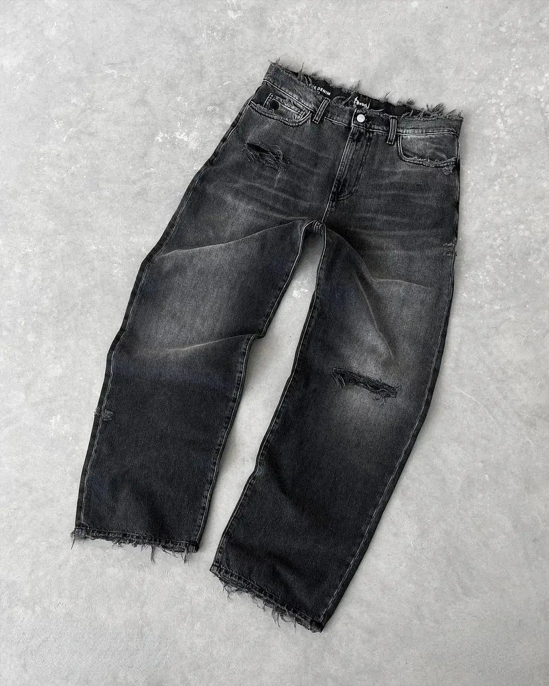 Men's straight jeans in black distressed denim with ripped knees, ankle length, frayed hems