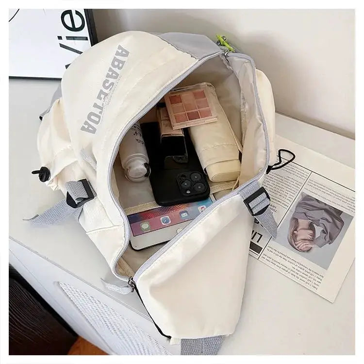 Cream nylon crossbody bag by Simples Market; unisex chest pack shown open with phone and cosmetics inside