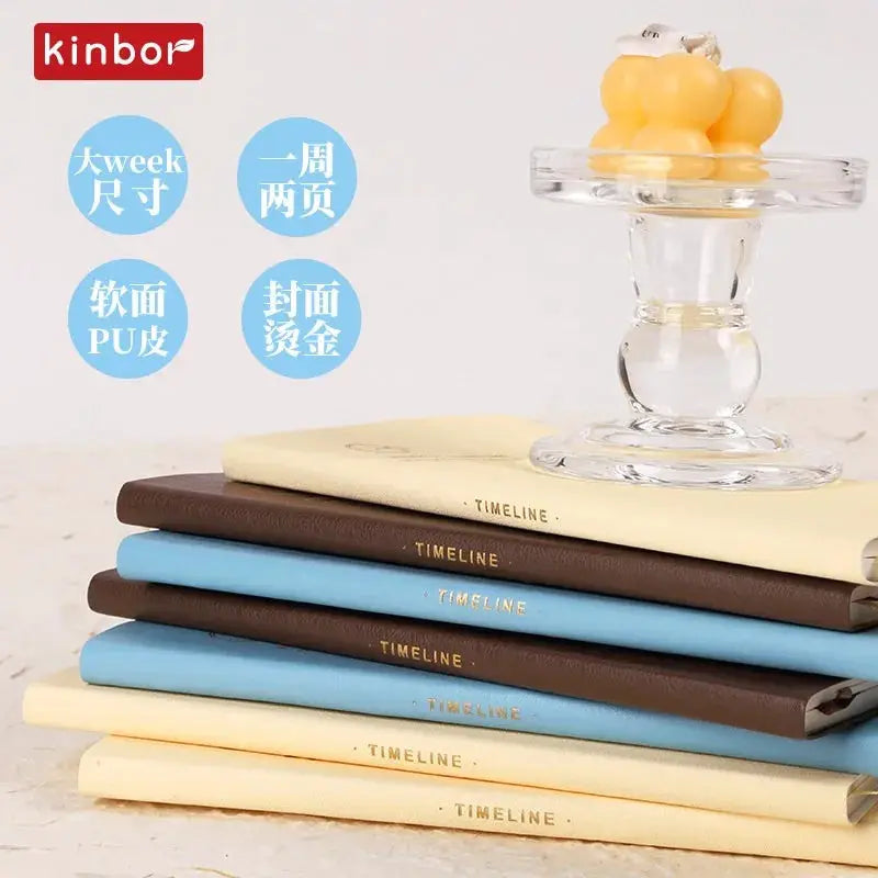 Kinbor set of six weekly planner notebooks with soft PU leather covers and gold-foil TIMELINE spines.