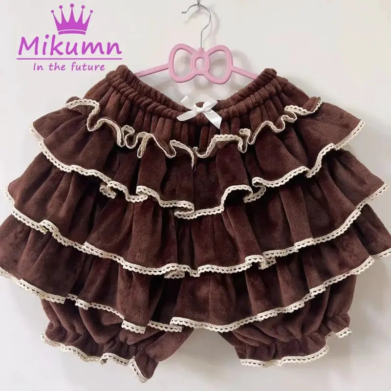 Lantern shorts in brown plush fabric with cream lace trim; Mikumin logo visible