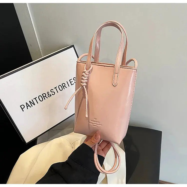 Blush pink PU leather mini crossbody bag with top handles and knotted strap detail