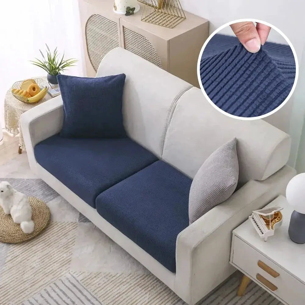 Sofa cover set for a two-seat couch in navy blue polar fleece stretch fabric on a beige sofa; removable protector