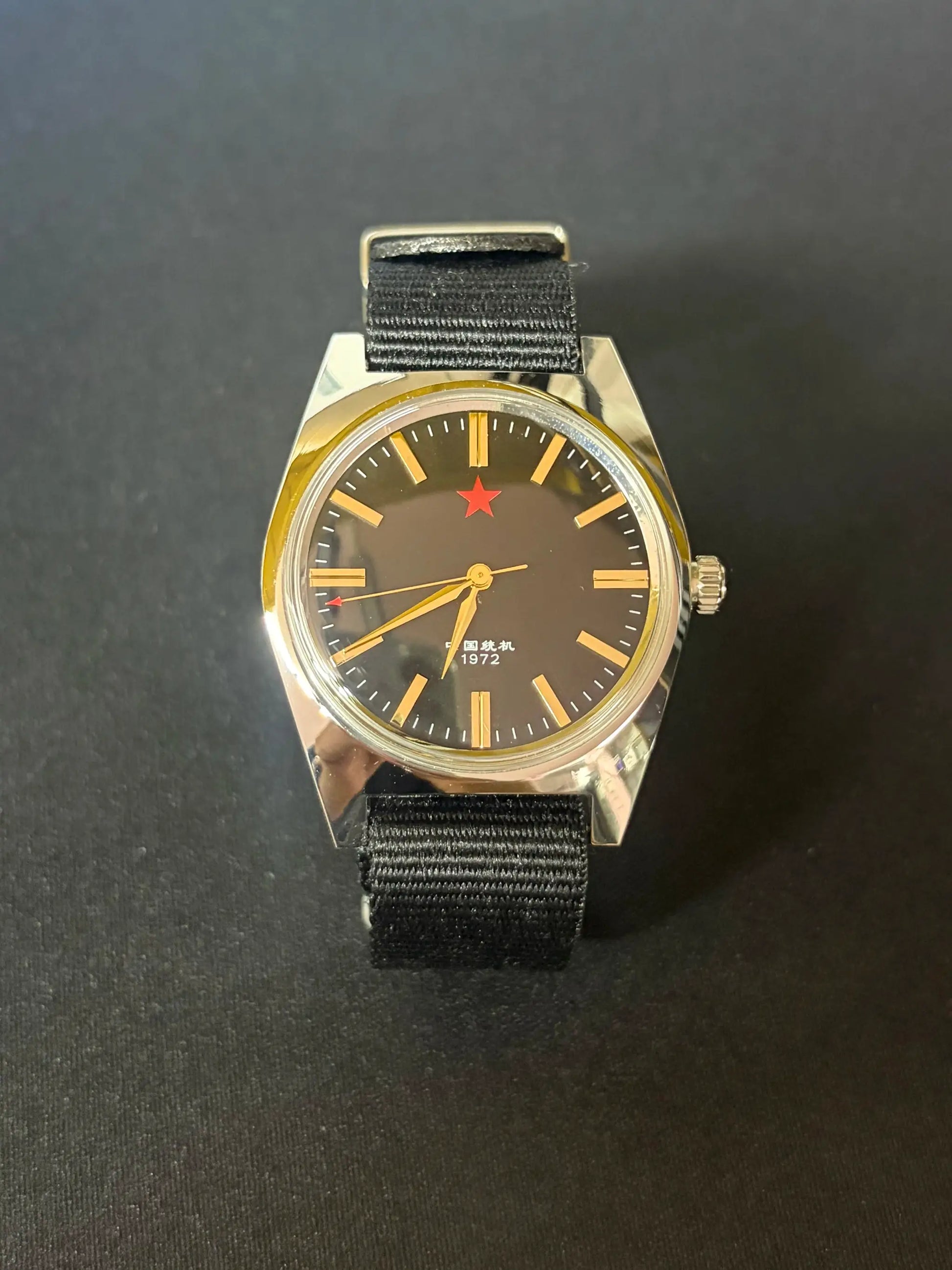Men's mechanical watch with black dial, gold-tone indices, red star, stainless steel case, black nylon strap