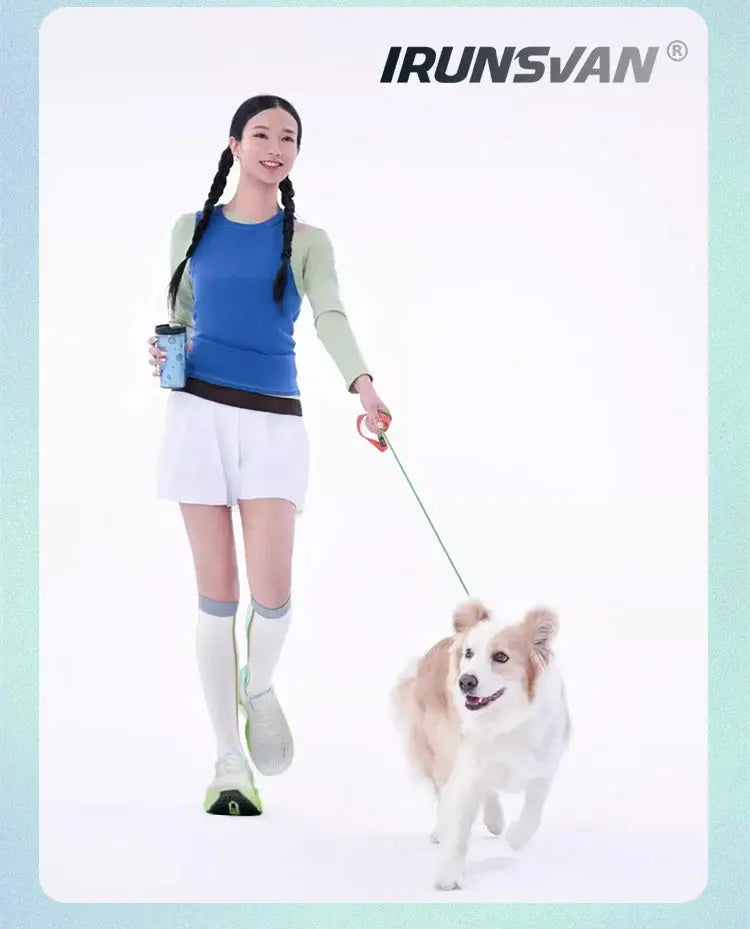 IRUNSVAN carbon fiber running sneakers, white with lime-green accents worn by a woman walking a dog