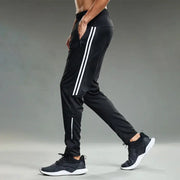 Men's black jogging sport pants with white side stripes and zip pockets