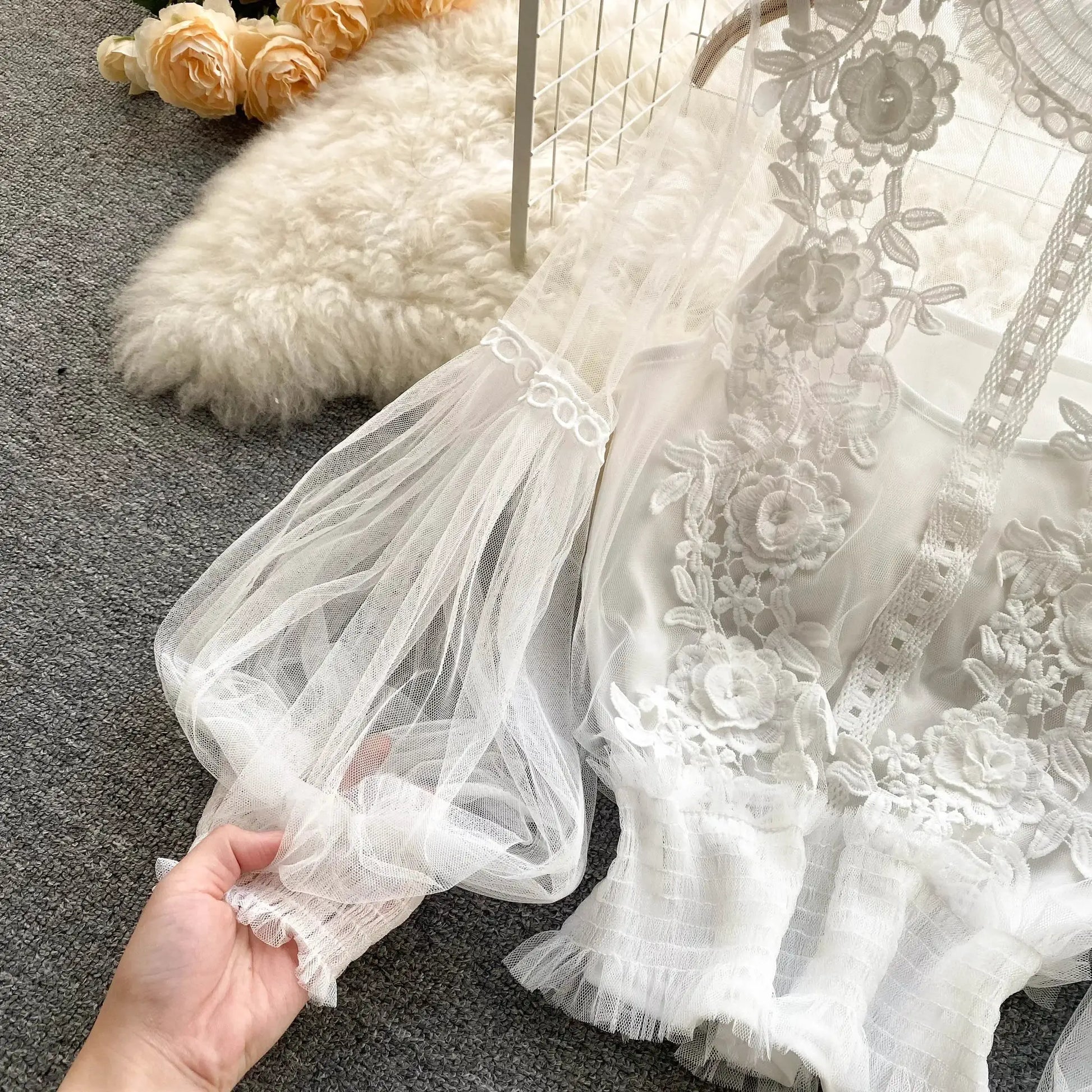 White lace puff-sleeve blouse with floral embroidery and sheer, scalloped edges