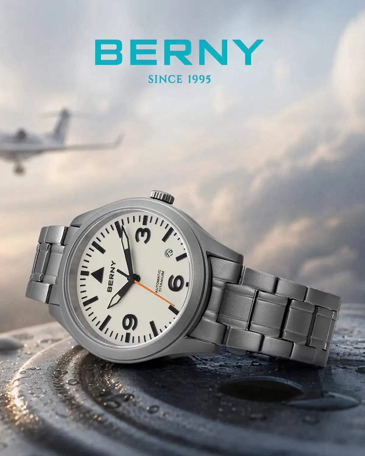 BERNY aviation titanium watch with white dial, black numerals, orange second hand, and brushed steel bracelet.