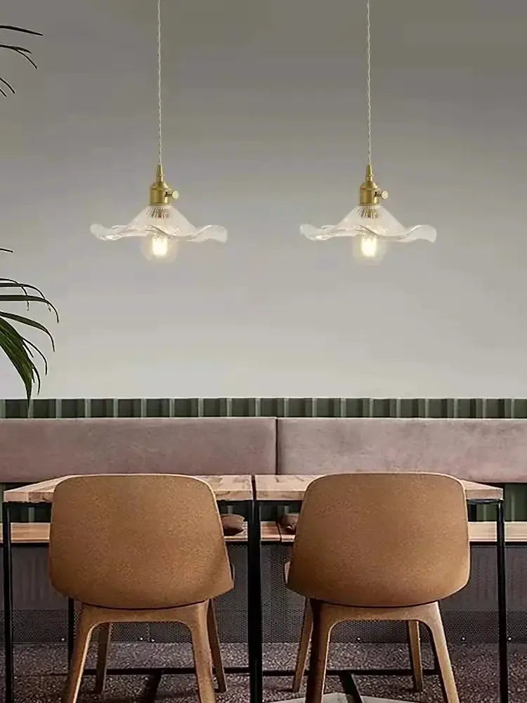Nordic Minimalism LED pendant lights by Simples Market; copper fixtures with clear glass shades, two hanging over a dining table