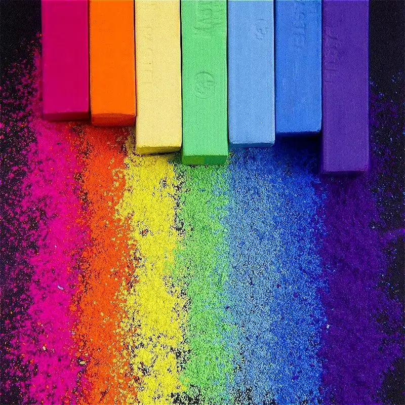 Soft pastel square chalk crayons in an 8-color rainbow set for drawing; chalk dust spreads on the colorful surface.