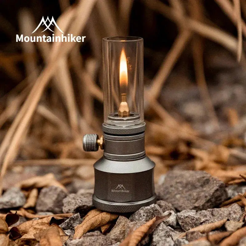 Mountainhiker gas light set with gray metal base and glass chimney for outdoor camping ambience.