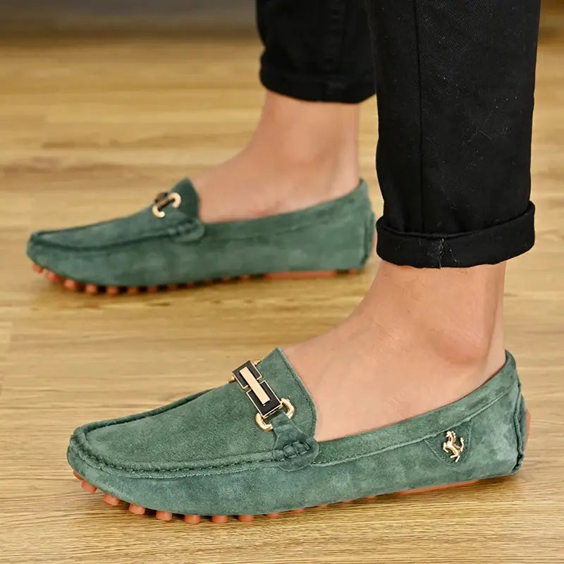 Green suede loafers for men by Simples Market, driving moccasin style with gold buckle and side logo