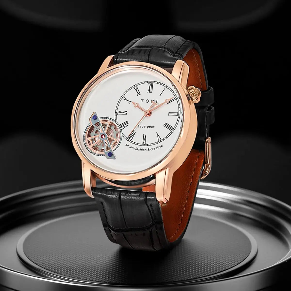 TOMI men's quartz watch with rose-gold case, white Roman-numeral dial, visible balance wheel, black leather strap.