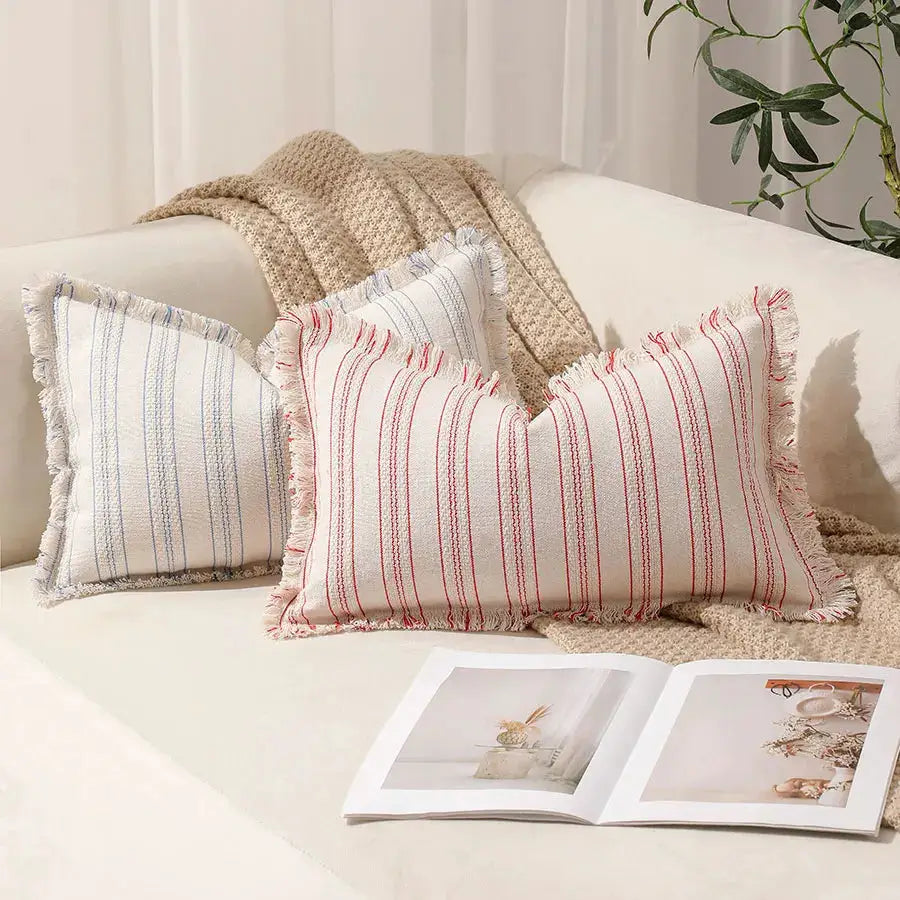 Summer Boho pillow covers 30x50, two striped fringe-edged covers in blue and red on a sofa
