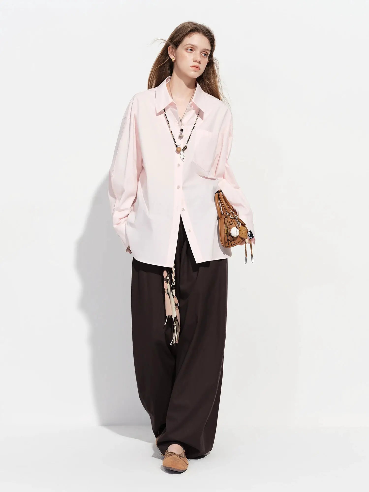 Women's pink oversized cotton shirt with long sleeves, collar, button-front, chest pocket.