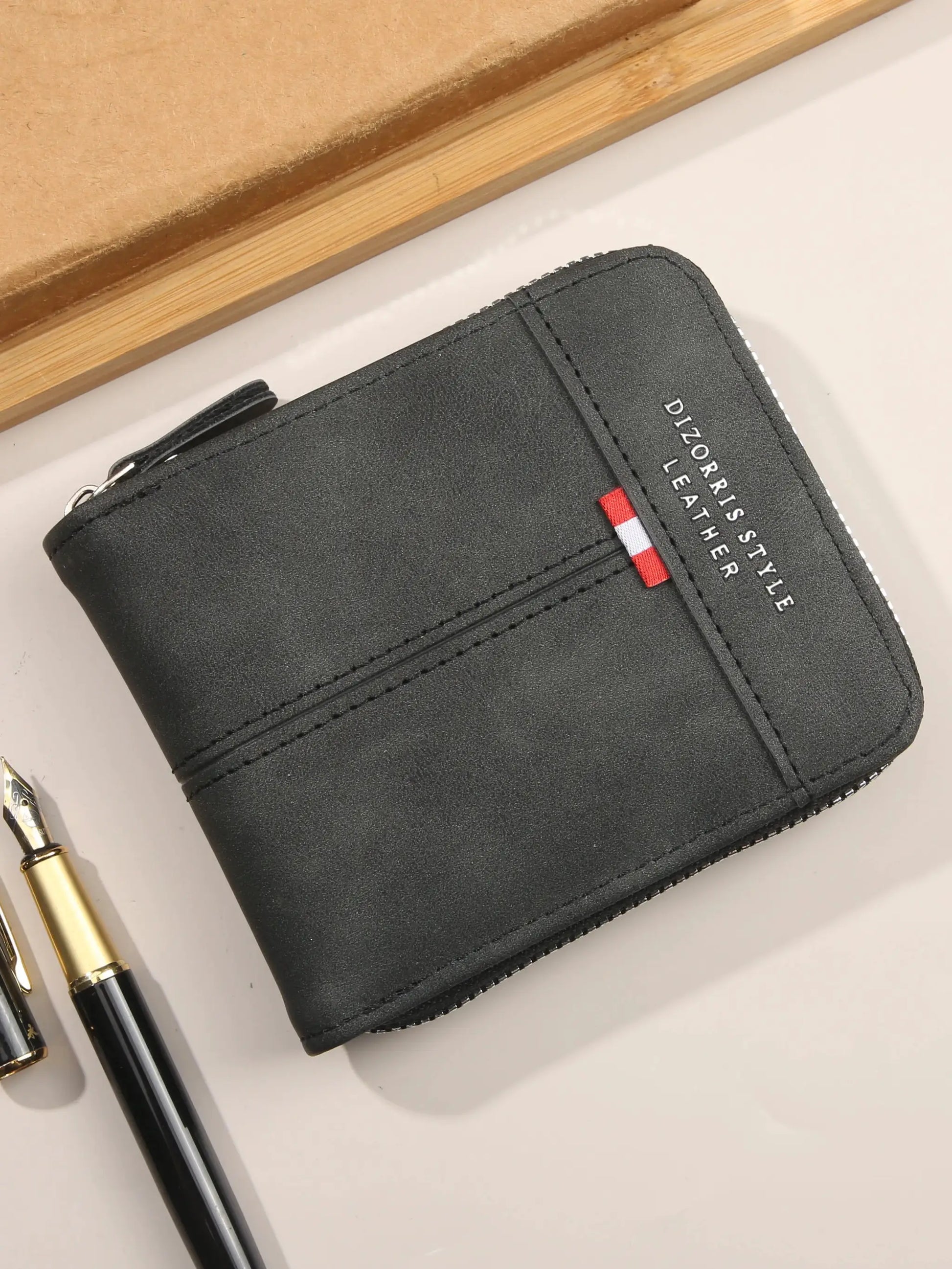 Men's black leather wallet with zip-around closure, compact tri-fold design and red-white tag accent