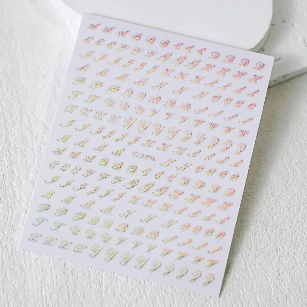 3D roman letter nail stickers sheet by Simples Market in iridescent gold, silver and black laser finish