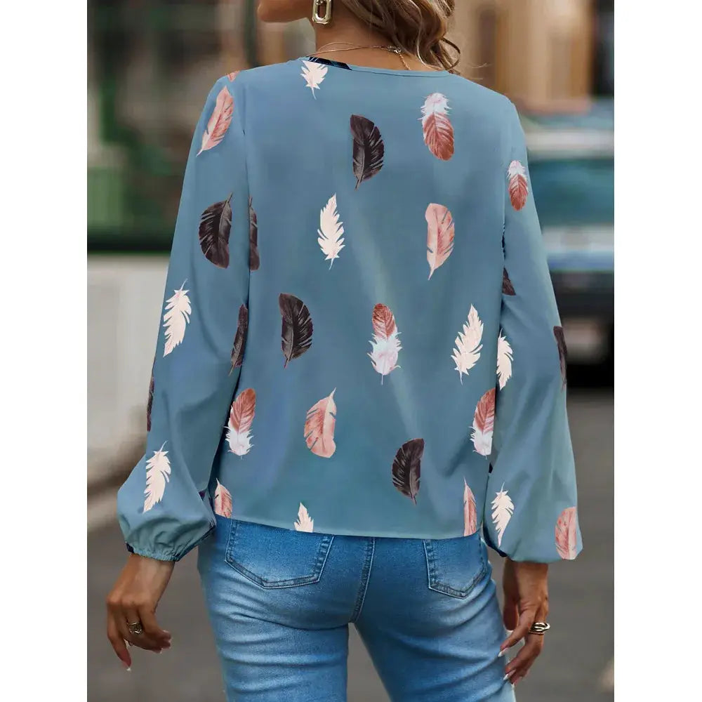 Feather-pattern chiffon blouse for women by Simples Market, blue long-sleeve top with multicolor feathers, back view.