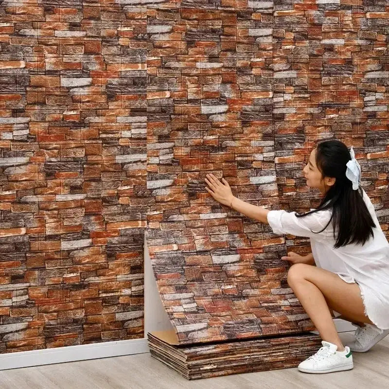 3D self-adhesive brick wallpaper, waterproof brown brick pattern; rolls and stacked panels as a woman applies it.