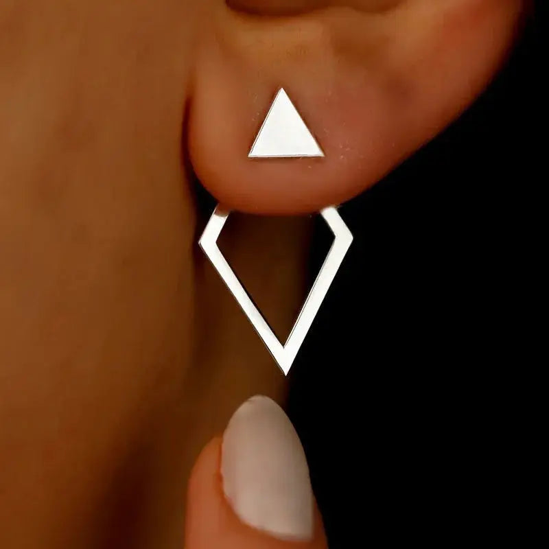 Stud earrings by Simples Market: silver geometric triangle stud with a hollow diamond drop