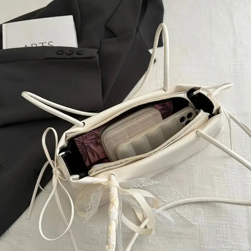 Simples Market PU cream square shoulder bag with bow lace decoration, open to reveal phone and wallet inside.