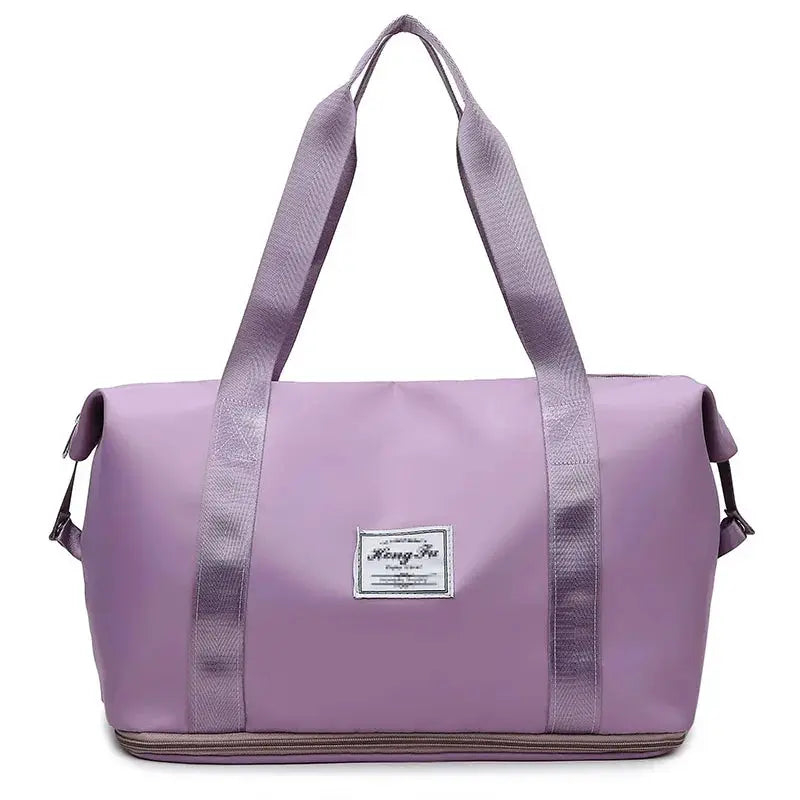 UNIXINU carry-on duffle bag in lavender nylon, waterproof with wide purple handles and large capacity.