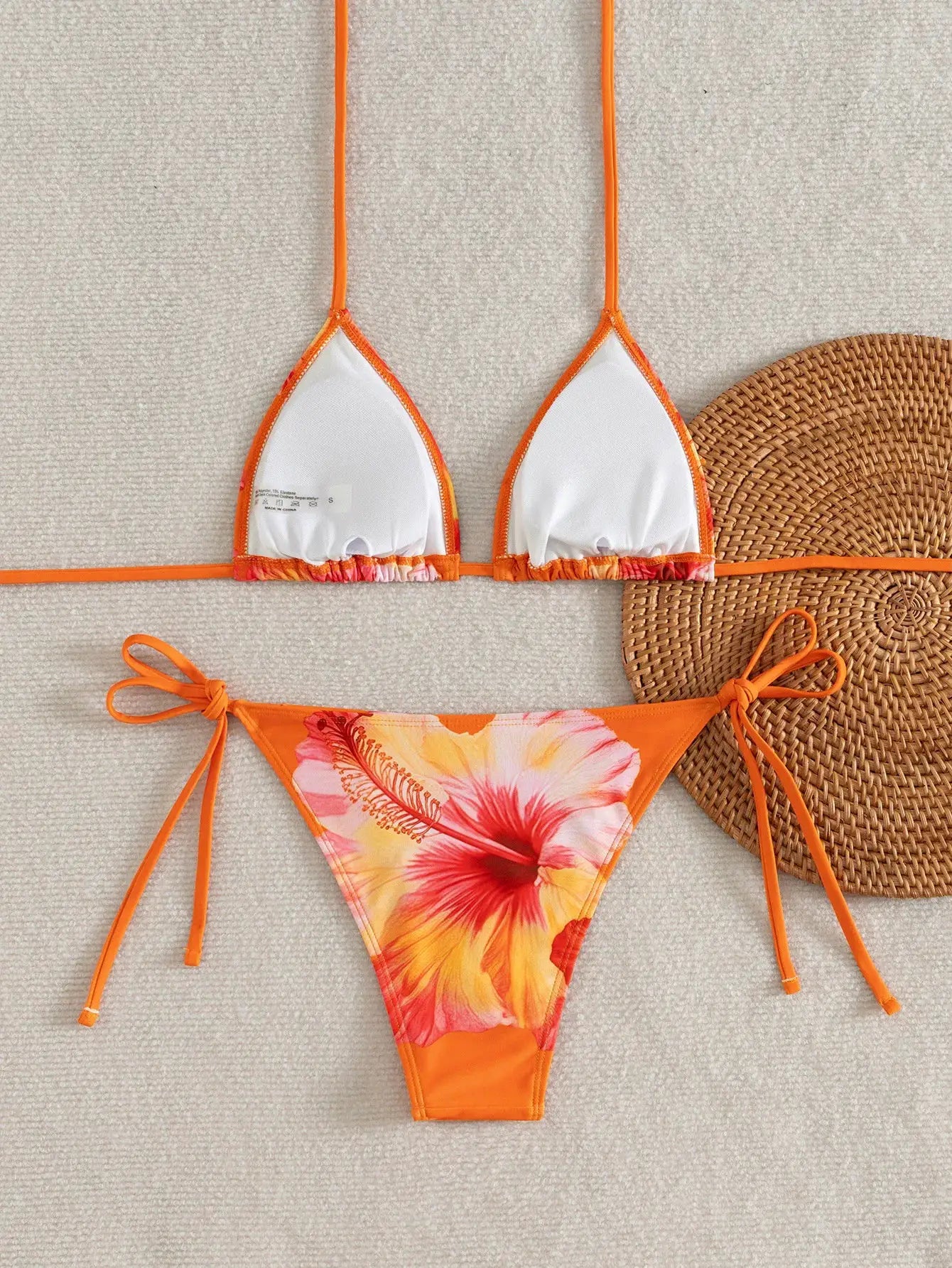 Simples Market bikini set: orange floral tie-side bottom with white triangle top and adjustable straps.