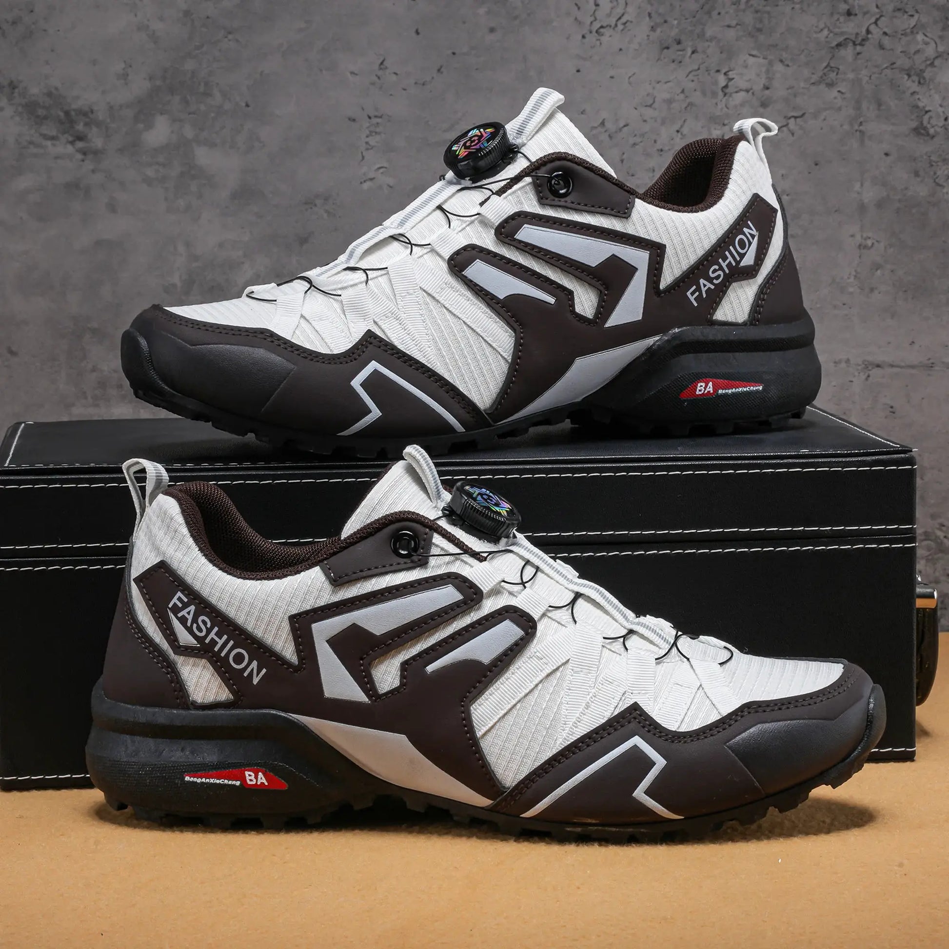Pair of men's outdoor casual shoes in white with brown overlays and black outsole; fashion branding on side.