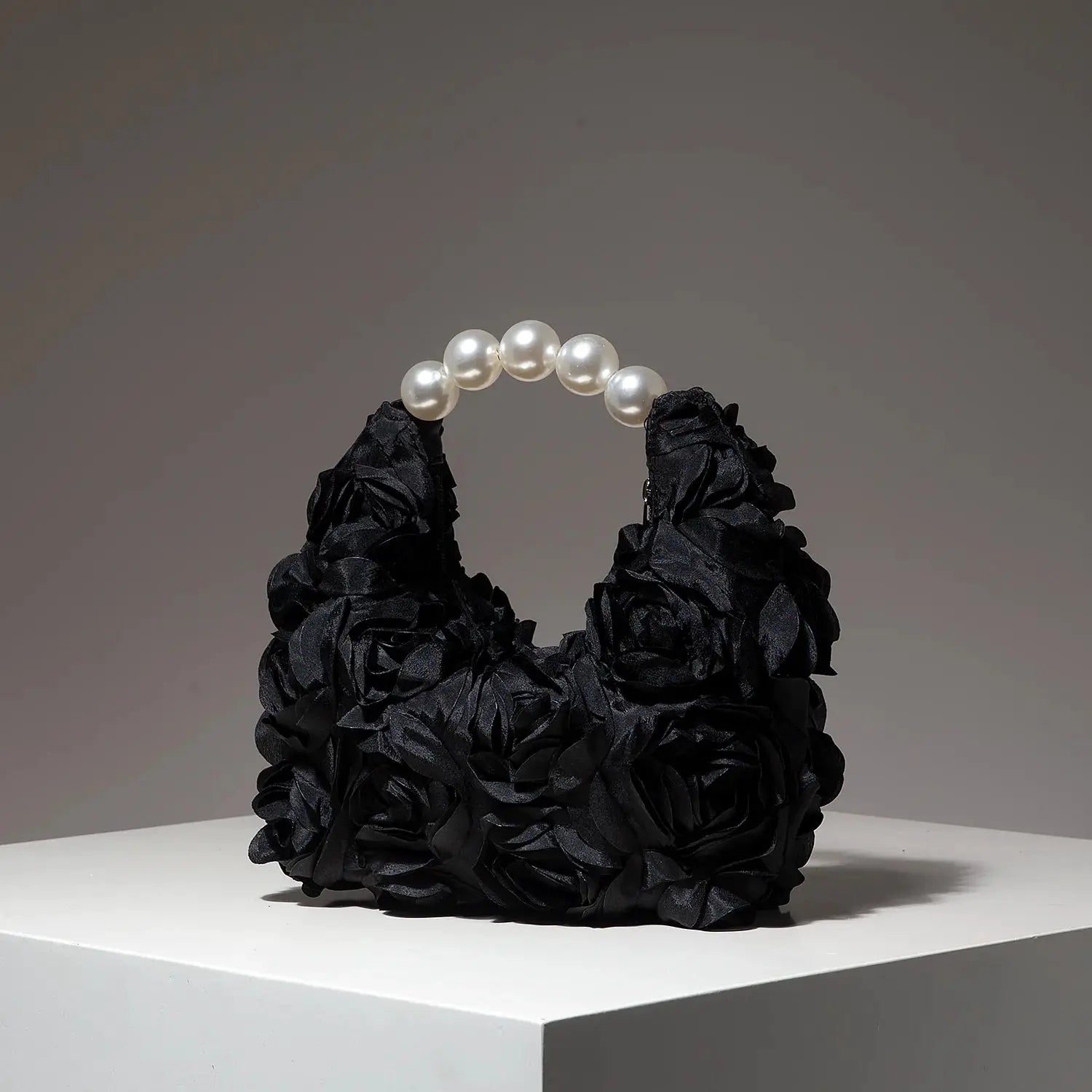 Floral rosette clutch bag in black with pearl handle by Simples Market