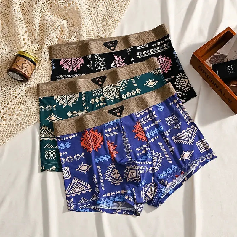 3-pack men's ice-silk boxer shorts with tribal geometric prints in blue, teal, and black; beige elastic waistbands.