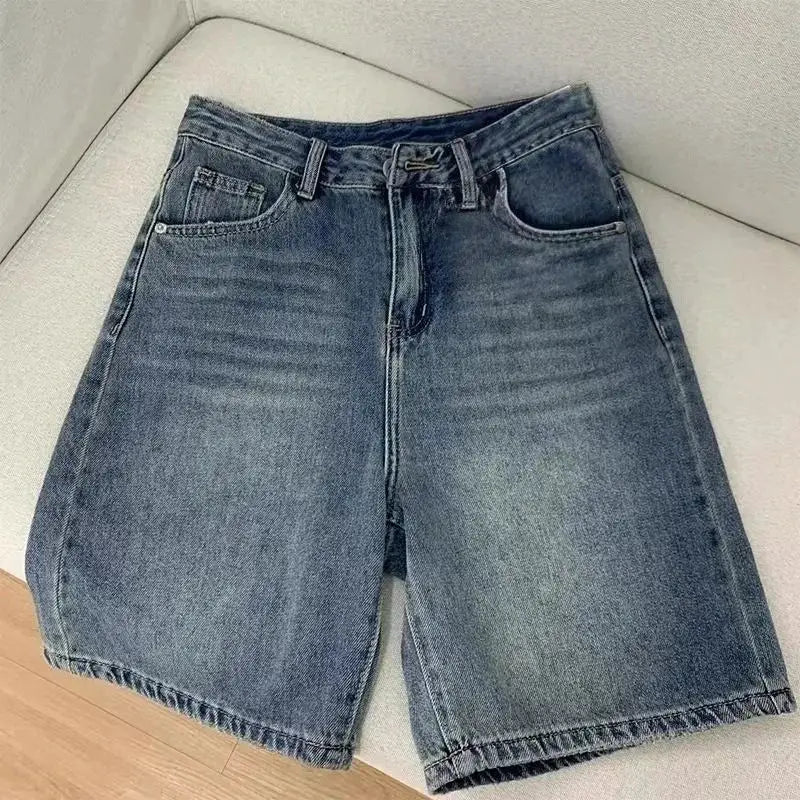 Women's blue denim knee-length shorts, high-waist, casual summer style.