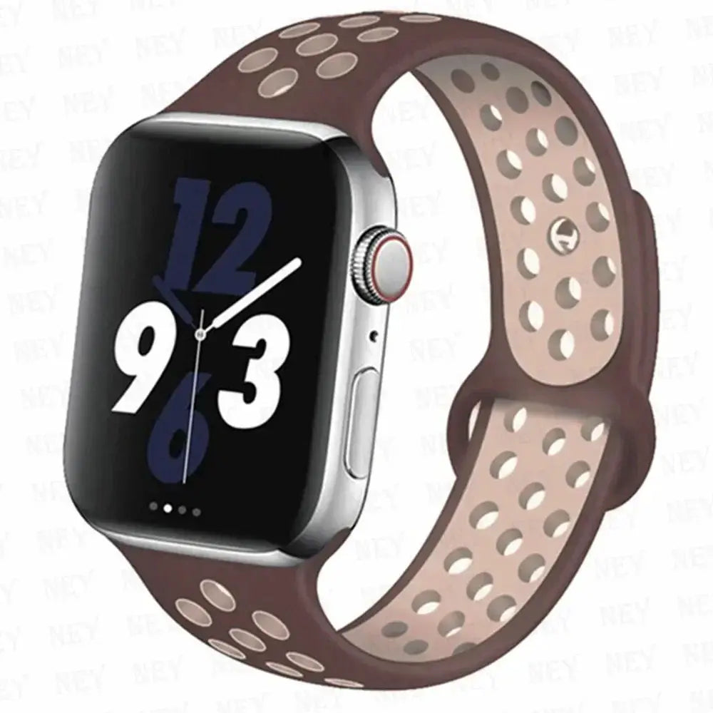 Silicone sport strap for Apple Watch, brown with pink perforated underside; Pride bracelet style, fits 38–45mm.