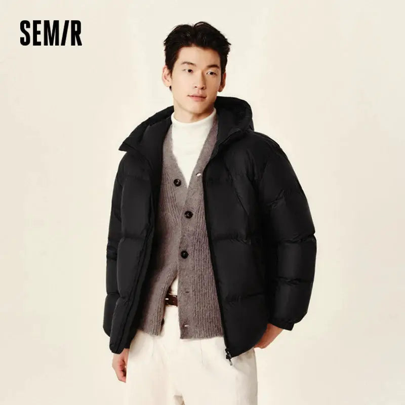Semir black puffer hooded down jacket on male model, men's winter outerwear with quilted panels and zip closure