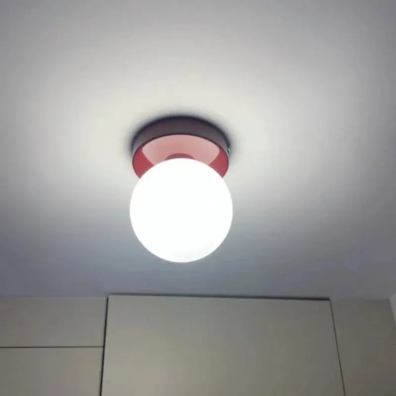 Macaron-style wall lamp with iron base and white plastic ball shade, red accent ring