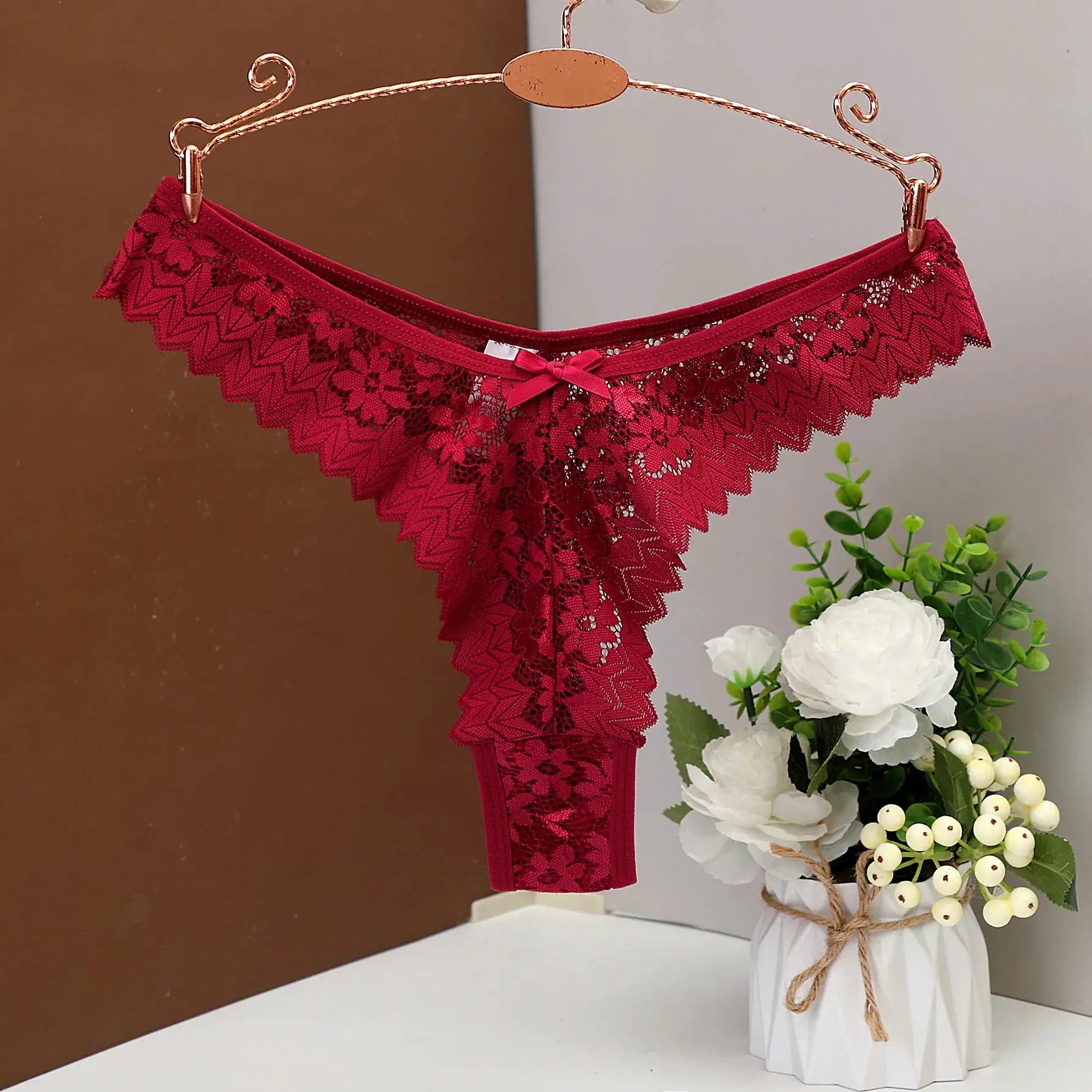 Women's red lace thong with scalloped edges and butterfly pattern; breathable low-rise underwear.
