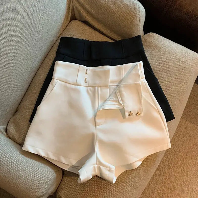 Women shorts: white high-waisted A-line shorts with a black pair behind, Simples Market