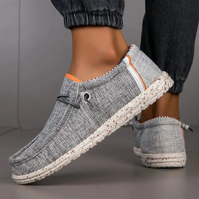 Men's gray canvas loafers with orange trim and speckled sole; breathable casual driving shoes