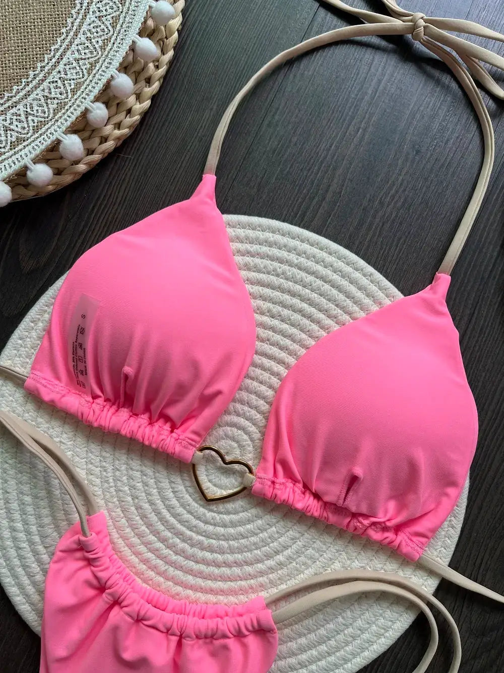 Pink halter two-piece bikini set with triangle cups, heart-ring detail, beige straps, string-tie bottoms Simples Market