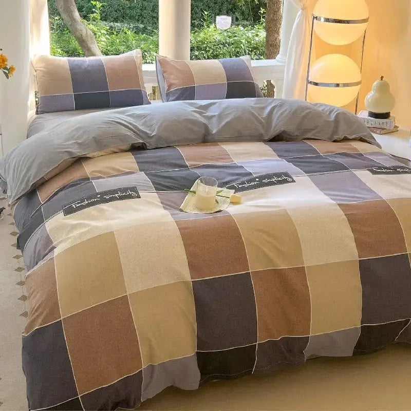 Bed set with beige, blue, gray, and brown patchwork plaid duvet cover and matching pillowcases
