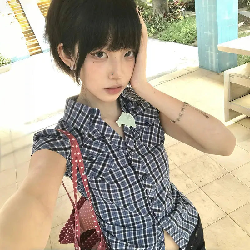 Karrram Japanese Y2k plaid shirt by Simples Market; navy-blue check short-sleeve blouse on model with a polka-dot bag.