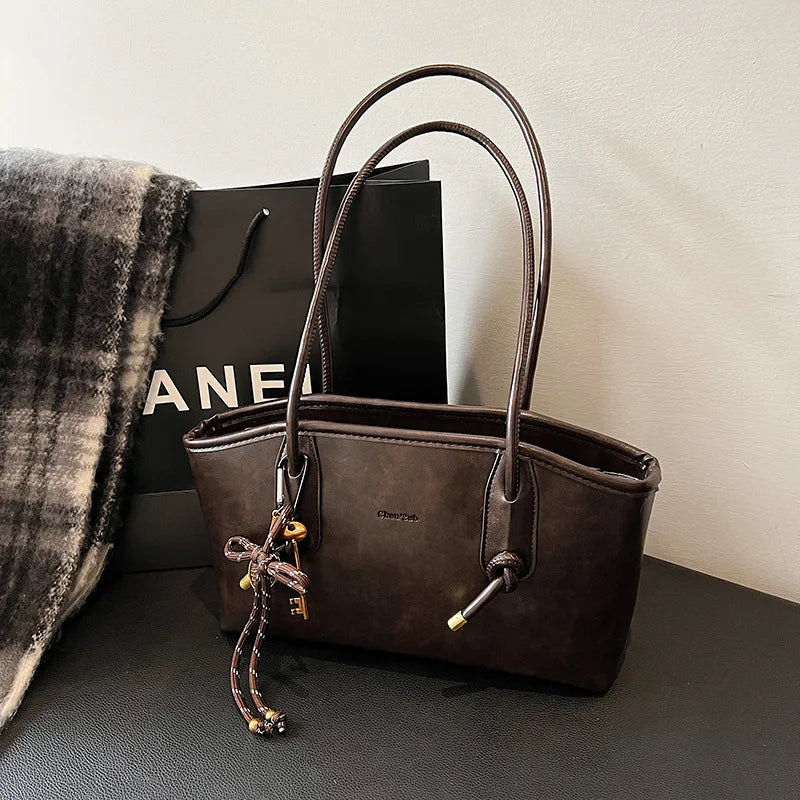 PU leather shoulder bag for women, brown tote with dual top handles and a decorative keychain charm