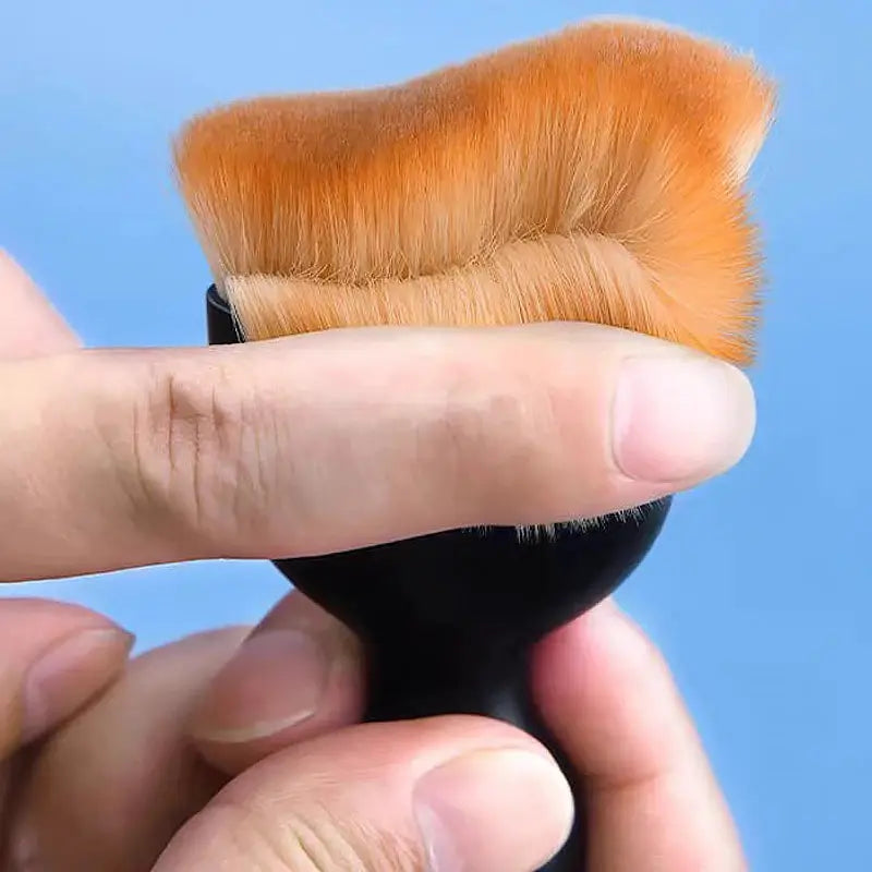 Car interior cleaning brush with thick orange fur and black handle