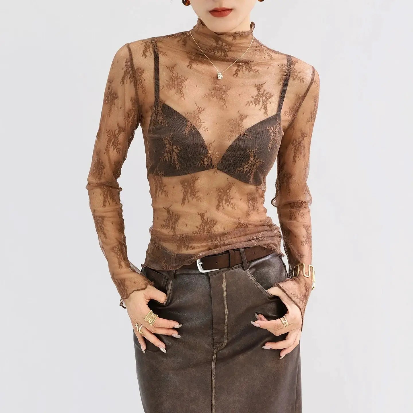 Sexy women's mesh lace blouse; sheer brown floral long-sleeve top over a black bra