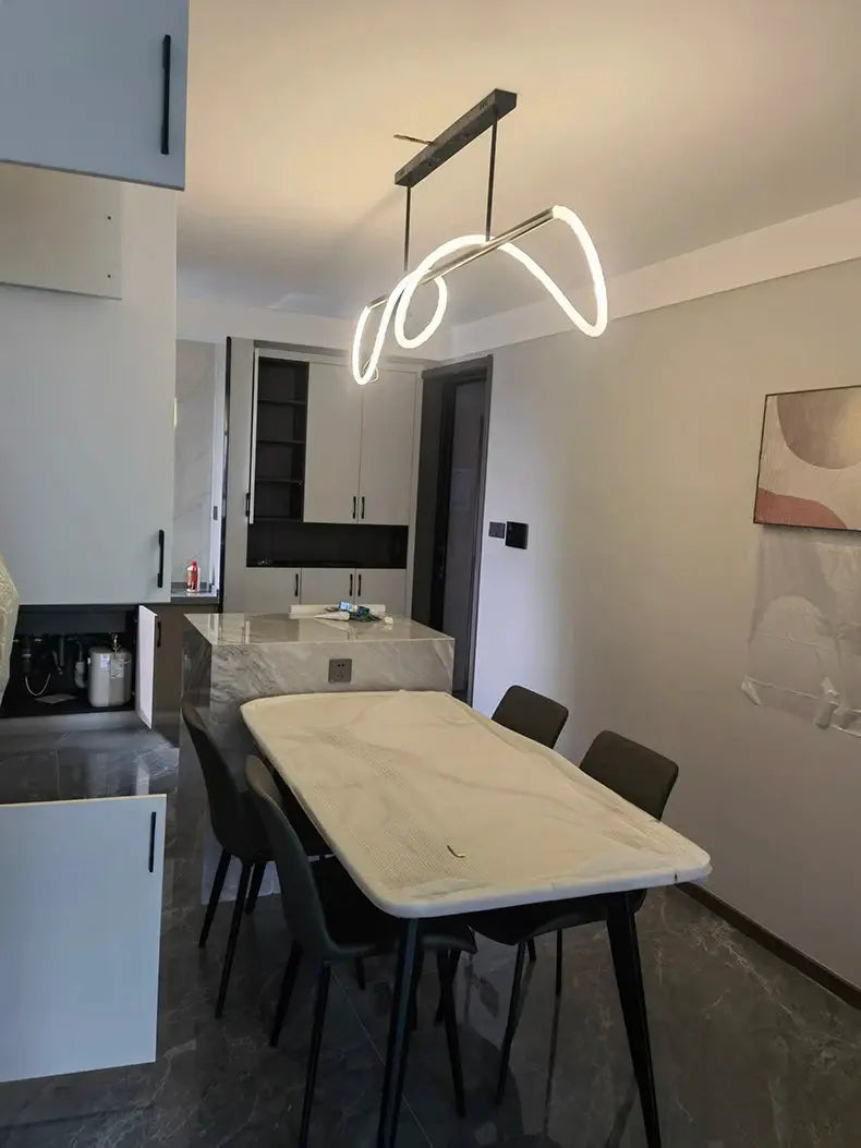 Nordic pendant chandelier with white illuminated loop design for dining room by Simples Market