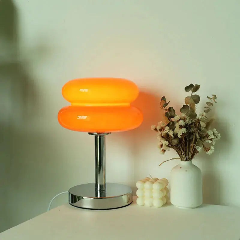 Macaron glass table lamp by Simples Market with orange double-globes and chrome base.