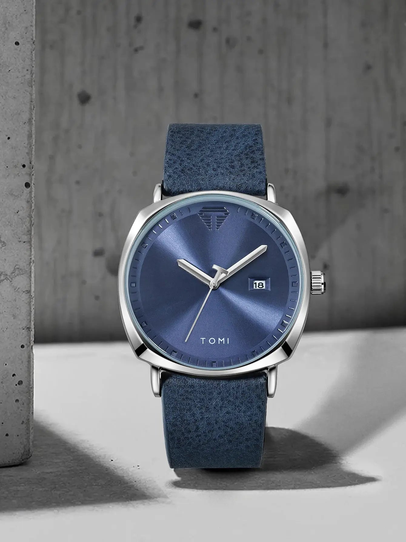 TOMI men's minimalist quartz watch with blue dial, date window at 3 o'clock, silver case, blue suede strap
