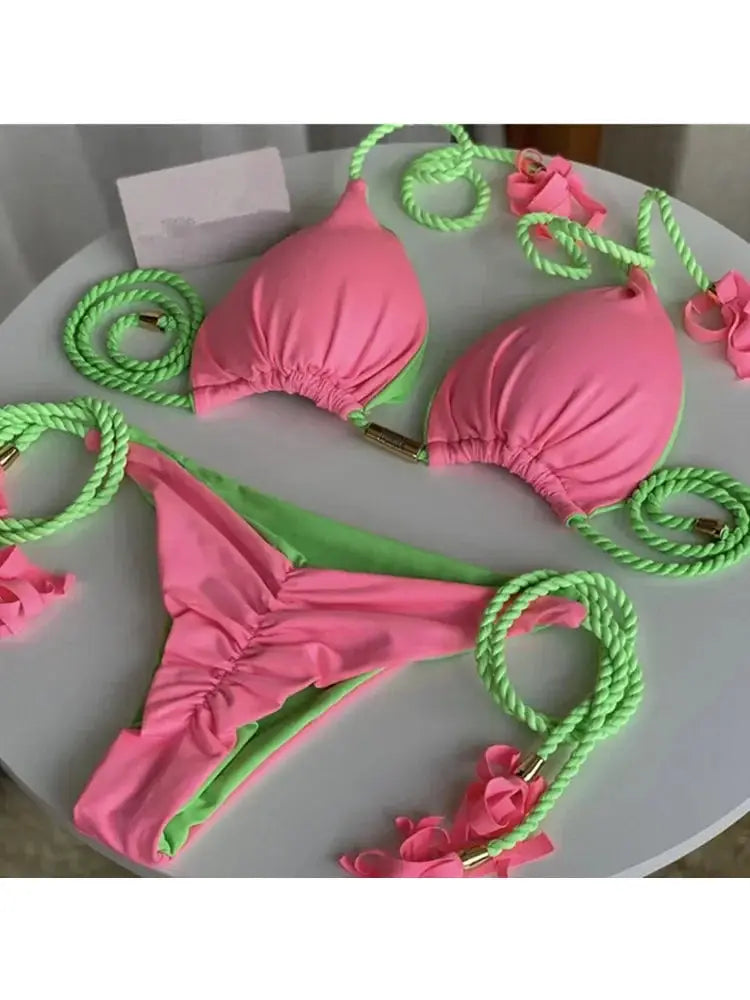 Pink triangle bikini with neon green rope ties; backless multicolor swimsuit set