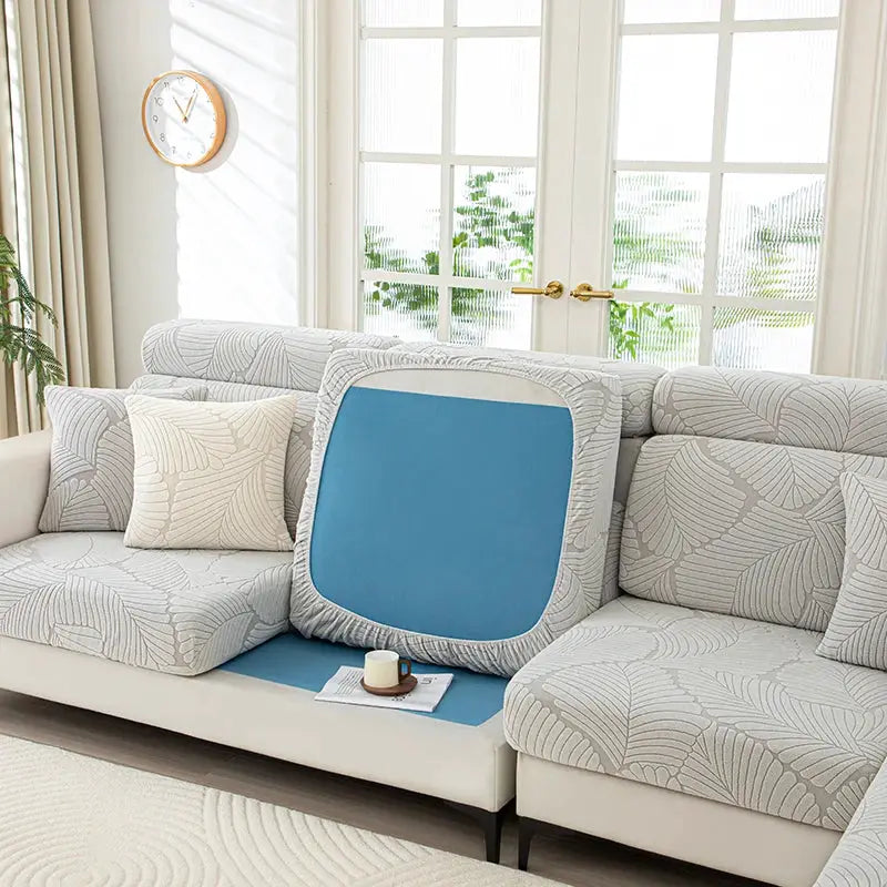 Simples Market thick plush sofa cover with elastic edges; blue cushion insert on light gray leaf-pattern sofa